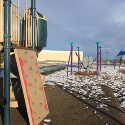 Ridge Recreation Center & Indoor Pools - Multiple play structures at the Ridge rec outdoor park including zip slides and zip line.
