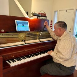Frank's Piano Tuning & Repair - Frank listens to and watches each string's pitch as he tightens.