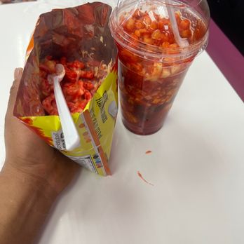 Mia's La Michoacana - a hand holding a plastic cup with a straw and a bag of salsa - Ice Cream & Frozen Yogurt Near Me - Crystal Lake, Illinois Mia's La Michoacana - a hand holding a plastic cup with a straw and a bag of salsa - Ice Cream & Frozen Yogurt Near Me - Crystal Lake, Illinois