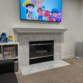 Home Style Designs - a television mounted above a fireplace - Flooring Near Me - Upland, California