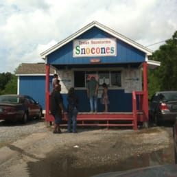 two men standing outside of a store