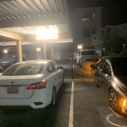 Assigned parking on left. Handicap on right. Electric charging port in between. Wtf?! It's like this everywhere Assigned parking on left. Handicap on right. Electric charging port in between. Wtf?! It's like this everywhere