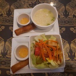Side thai salad and rice sipe with spring rolls.
