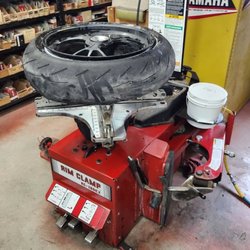Outlaw Motor Sports - Tire machine with a bald Ducati tire.