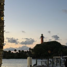 Jupiter lighthouse at sunset taken from Lucky Shucks outdoor seating area Jupiter lighthouse at sunset taken from Lucky Shucks outdoor seating area