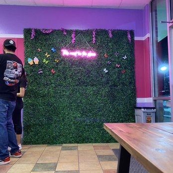 Daisy's Neveria - a man standing in front of a wall of flowers - Ice Cream & Frozen Yogurt Near Me - Lavon, Texas