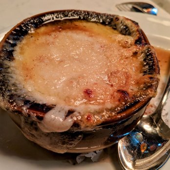 Le Monde - a plate of food with a spoon and spoon - French Near Me - New York, New York Le Monde - a plate of food with a spoon and spoon - French Near Me - New York, New York
