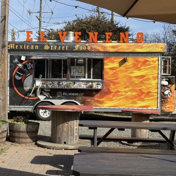 El Veneno - El Veneno truck with a great seating area with tables and umbrellas - Mexican Near Me El Veneno - El Veneno truck with a great seating area with tables and umbrellas - Mexican Near Me
