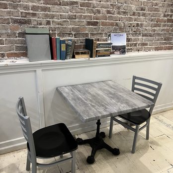 Savoy Tea Co - a table and two chairs in front of a brick wall - Coffee & Tea Near Me - Fayetteville, Arkansas Savoy Tea Co - a table and two chairs in front of a brick wall - Coffee & Tea Near Me - Fayetteville, Arkansas