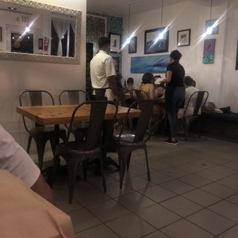 Estela - chef checking on tables - Caribbean Near Me - Rincón, Puerto Rico