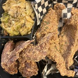 Fried fish, chicken wings and cabbage.