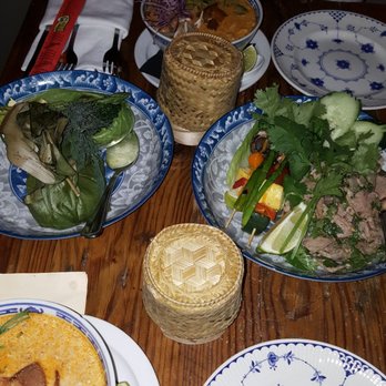 Bida Manda - Seabass in top left corner, and duck larb on the right side. Served with sticky rice. Pork belly soup split into 2. - Laotian Near Me - Raleigh, North Carolina Bida Manda - Seabass in top left corner, and duck larb on the right side. Served with sticky rice. Pork belly soup split into 2. - Laotian Near Me - Raleigh, North Carolina