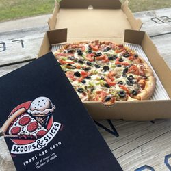 Backdoor Deli - Cover of restaurant menu and picture of the pizza we ordered.
