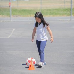Euro School of Tennis - After School Soccer - Kids practice dribbling through cones.