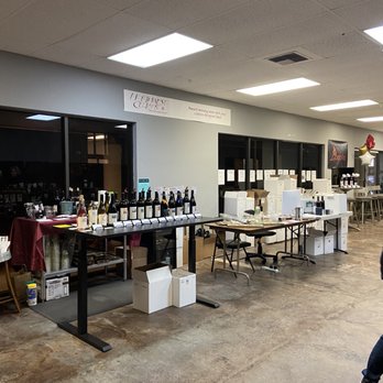 Northwest Cellars - a man walking through a wine tasting room - Wineries Near Me - Kirkland, Washington