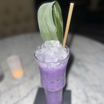 The Copper Lounge - a purple drink with a green leaf on top - Lounges Near Me - Albuquerque, New Mexico
