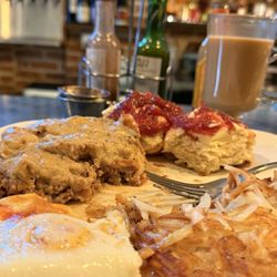 The Old Post - Chicken fried steak and eggs with hash browns and a freshly made biscuit with butter and raspberry jam