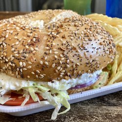 Bagel International & Deli - Chicken salad with lettuce, tomato and onion on a toasted everything bagel. Giant and delicious sandwich.