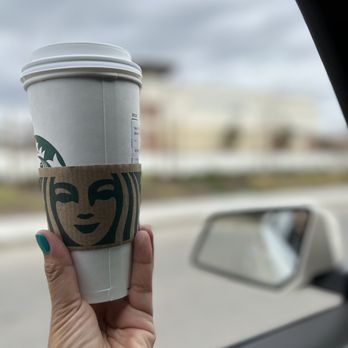 Starbucks - a hand holding a cup of coffee - Coffee & Tea Near Me - Bakersfield, California