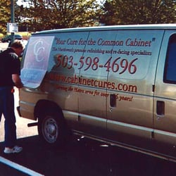Sign Scope Signs - Duane adding decals to a van.