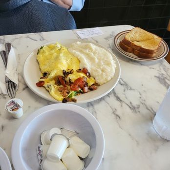 The Breakfast Place - House Omelette, consisting of onions, tomato, broccoli, mushrooms, ham, and Swiss cheese, with a side of grits and toast ($9.90). - Breakfast & Brunch Near Me - Savannah, Georgia