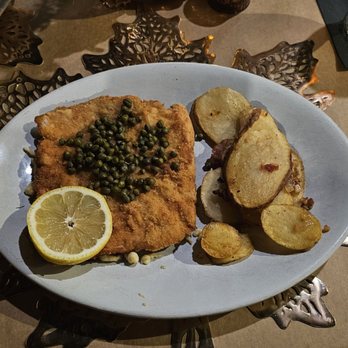 Steinhaus Keller - Wiener Schnitzel with lemon capers. Fried potatoes with bacon and onion. The Spaezle that was overcooked is under the Schnitzel. - German Near Me - Hot Springs, Arkansas Steinhaus Keller - Wiener Schnitzel with lemon capers. Fried potatoes with bacon and onion. The Spaezle that was overcooked is under the Schnitzel. - German Near Me - Hot Springs, Arkansas