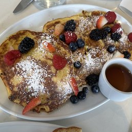 Ricotta pancakes Homemade ricotta pancakes with raisin, orange zest, organic maple syrup and fresh berries.
