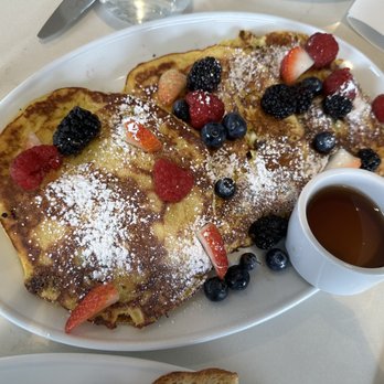 Emilia - Ricotta pancakes Homemade ricotta pancakes with raisin, orange zest, organic maple syrup and fresh berries. - Breakfast & Brunch Near Me - Los Angeles, California