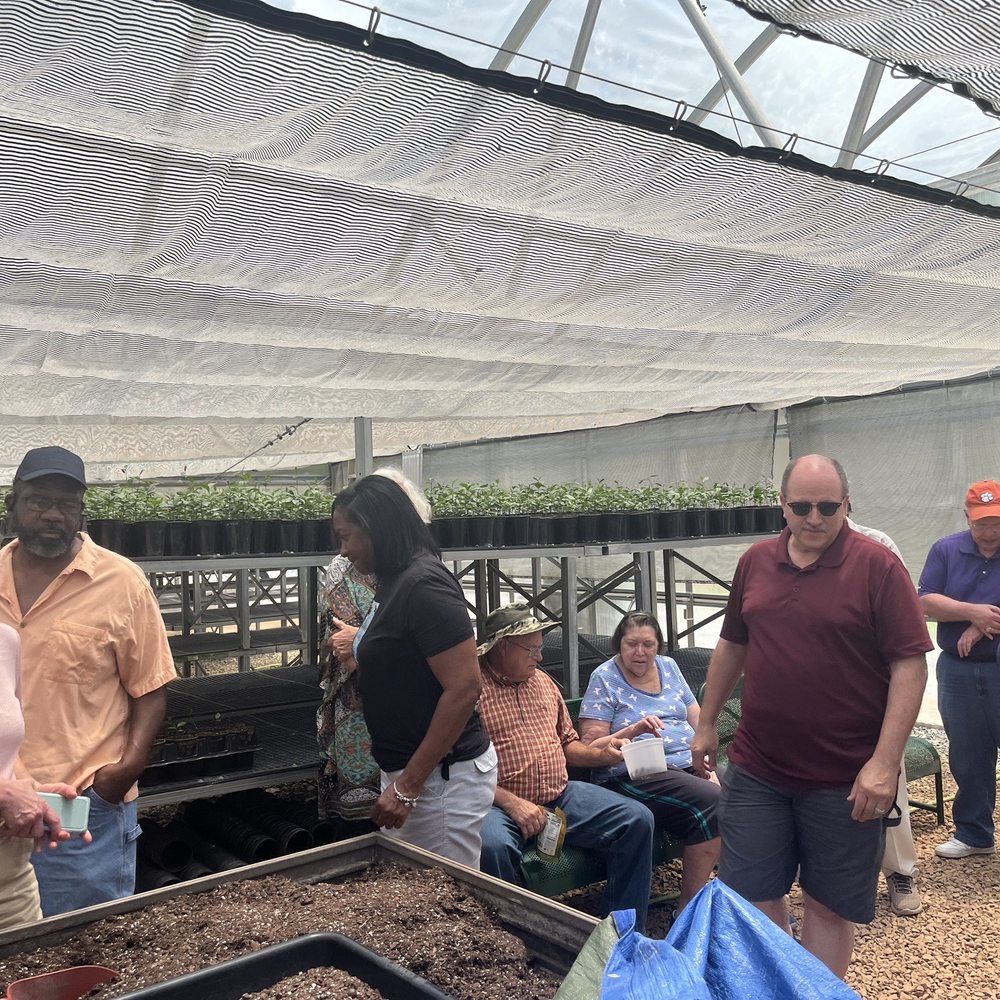a group of people in a greenhouse