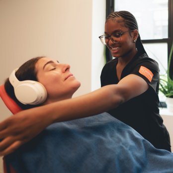 Domino Dental - Domino Dental patient with headphones on, enjoying her appointment - Cosmetic Dentists Near Me - Brooklyn, New York Domino Dental - Domino Dental patient with headphones on, enjoying her appointment - Cosmetic Dentists Near Me - Brooklyn, New York