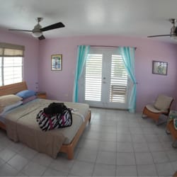 Acacia Guesthouse - Penthouse bedroom with French doors leading out to wrap around porch.