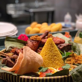 Wayan - "Tumpeng, a celebratory cone-shaped rice dish with an abundance of sides, meant to symbolize gratitude, togetherness, and harmony." - Indonesian Near Me - New York, New York
