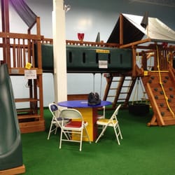 Rainbow Swing Set Superstore - This HUGE swing/slide/fort is only one of dozens of pieces of equipment inside the showroom.