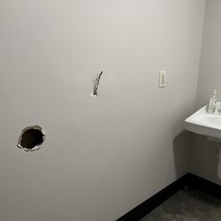 Speed Wash - SERIOUS SAFETY ISSUE - Giant hole & hot exposed wires coming out of Sheetrock wall next to sink in restroom !