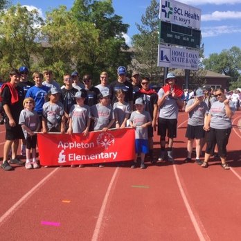 Fastsigns - Appleton Elementary Special Olympians with Fruita Monument High School football players. - Signmaking Near Me - Grand Junction, Colorado Fastsigns - Appleton Elementary Special Olympians with Fruita Monument High School football players. - Signmaking Near Me - Grand Junction, Colorado