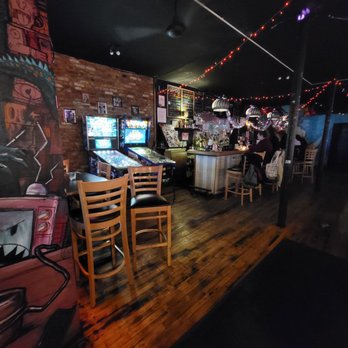 Jackbar - a man playing a video game at a bar - Bars Near Me - Brooklyn, New York