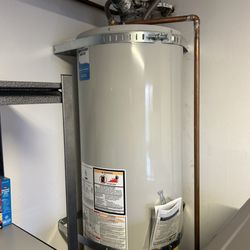 Pinson Plumbing - New water heater with ball valve shut off with new earthquake straps done per building code.