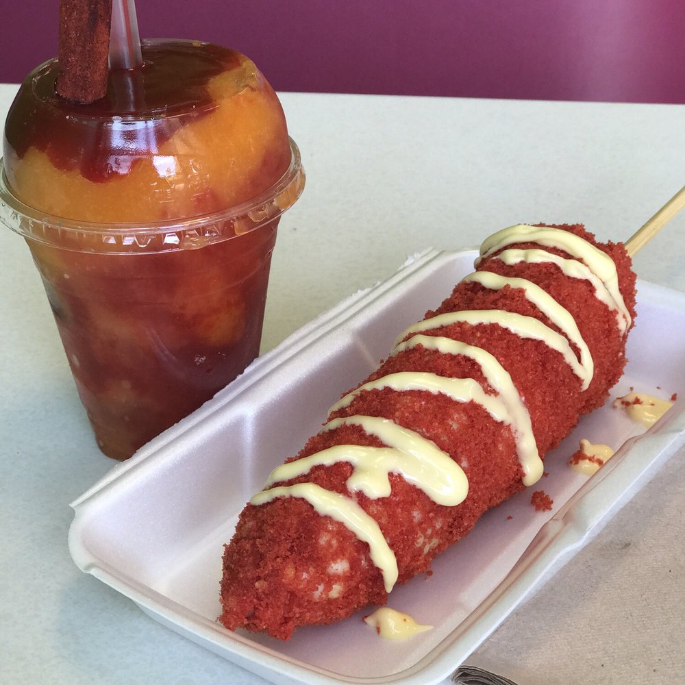 Mango diablito and corn on the cob with hot cheetos