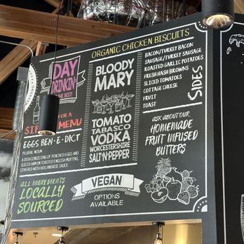 Brunch & Sip - Charcoal Art Wall - A chalkboard menu displays organic chicken biscuits, sides, and vegan options, with decorative illustrations and colorful text highlighting ingredients and options. - Coffee & Tea Near Me - Phoenix, Arizona