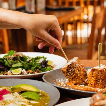Cielito Mexican Flavors - a person picking a piece of food from a plate - Mexican Near Me - Irving, Texas