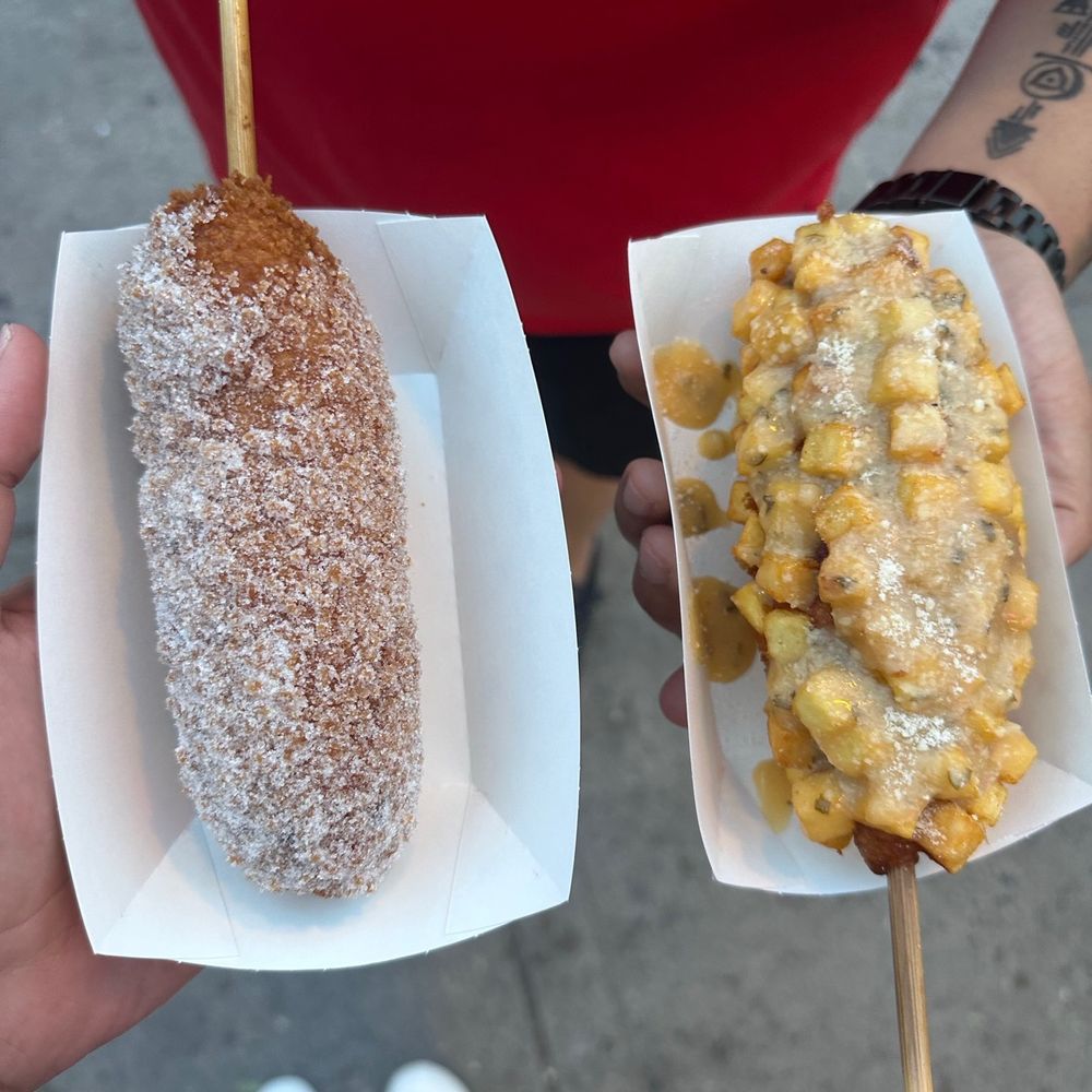 Chocolate corn dog with powdered sugar and mozzarella with potato's covered with garlic Parmesan sauce Chocolate corn dog with powdered sugar and mozzarella with potato's covered with garlic Parmesan sauce