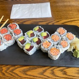 a plate of sushi and chopsticks