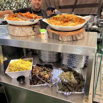 Hamitbach - a man standing behind a buffet of food - Wraps Near Me - San Diego, California