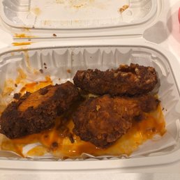 two trays of fried chicken with cheese sauce two trays of fried chicken with cheese sauce