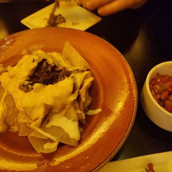 Territory Lounge - Burnt Ends Nachos, pico on the side. Not a lot of topping, but it was flavorful. Chips were kinda stale though. Pico was great! - Lounges Near Me - Lake Buena Vista, Florida