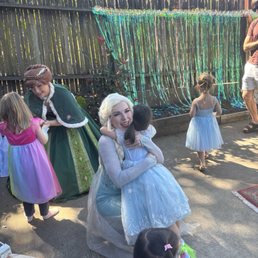 Birthday girl hugging Queen Elsa goodbye after a magical party Birthday girl hugging Queen Elsa goodbye after a magical party