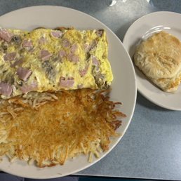 Ham, mushroom, & cheese omelet with hash browns and a biscuit