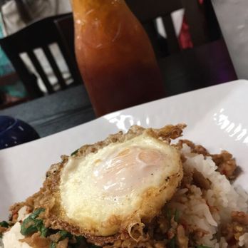 Sizzling Wok - Ground chicken w/ rice bedded with an over easy egg. - Thai Near Me - Long Beach, California