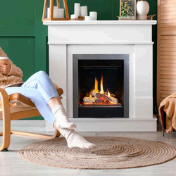 Fireplaces Unlimited Heating & Cooling - A woman sitting in a chair by an electric fireplace