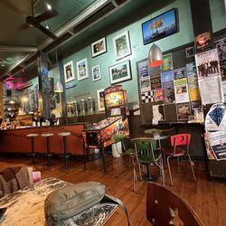 Midnight Espresso - Indoor area, Mandalorian pinball machine and local flyers showcasing local music